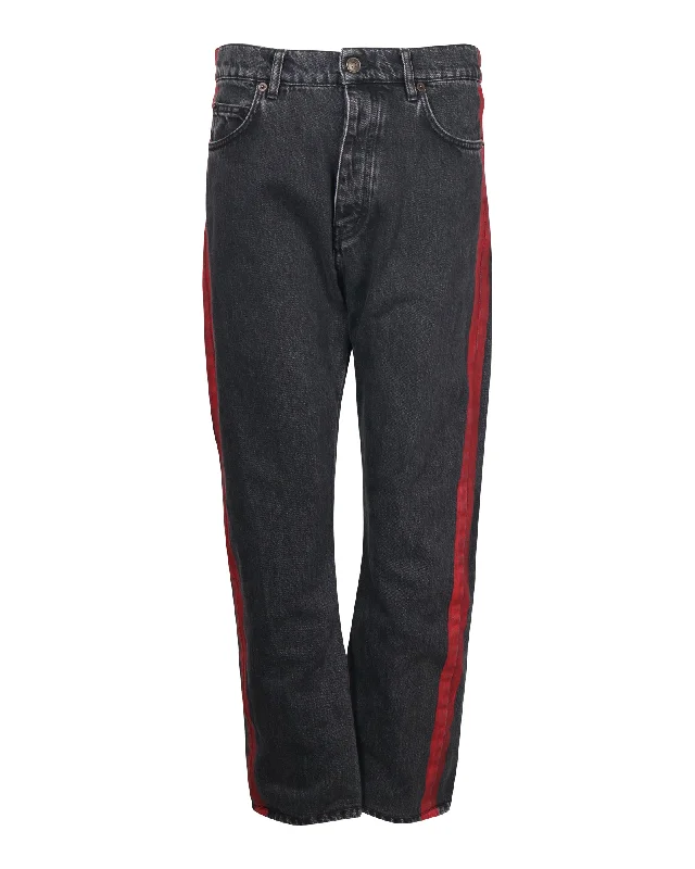 Classic tight trousers for women with smooth fabric and chic, timeless design -Balenciaga Denim Jeans with Red Stripe Detail in Black Cotton